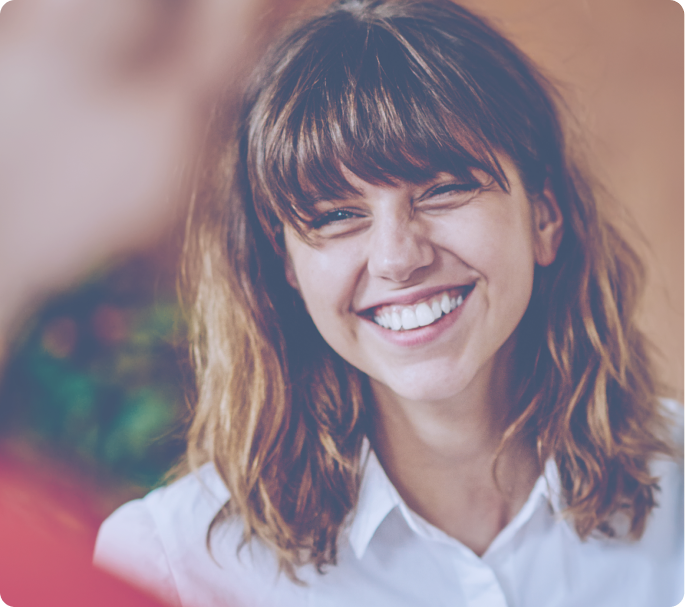 Woman smiling and looking at her coworker.